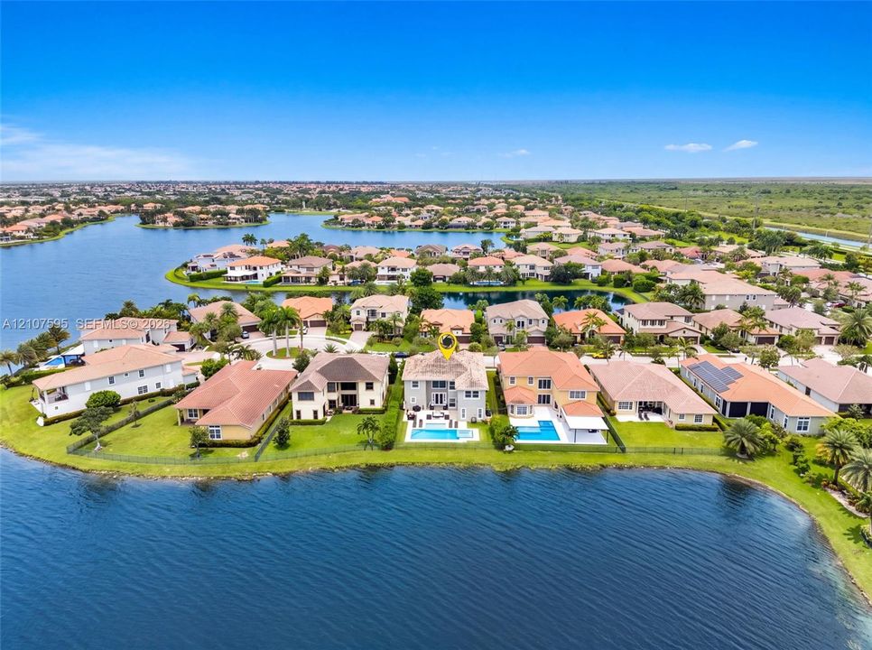 Waterfront property featuring a private swimming pool, concrete tile roof, and expansive lake frontage