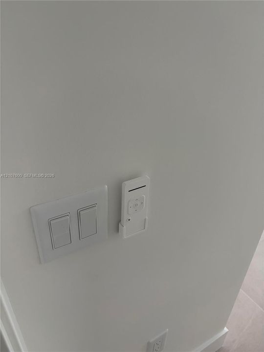 Wall-mounted remote control unit and dual rocker light switch