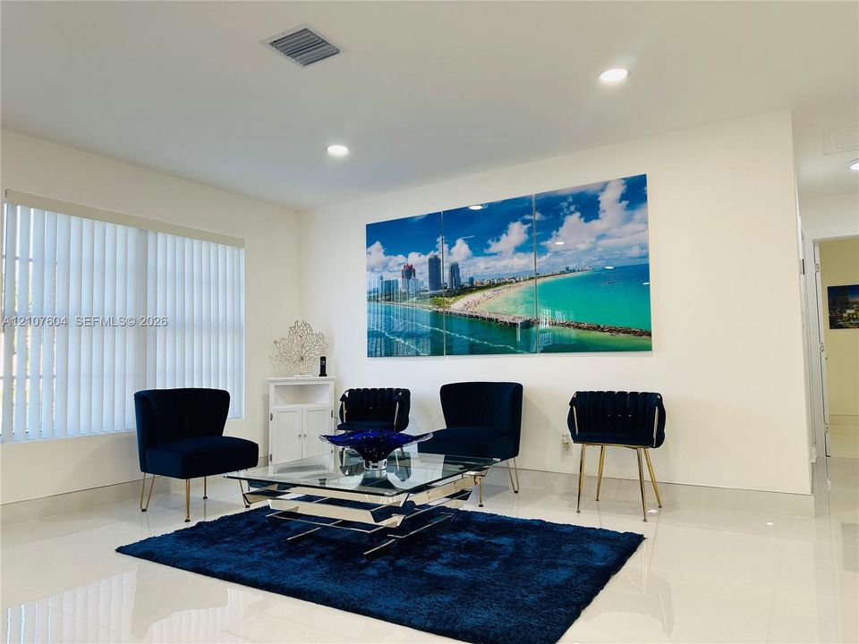 Interior space featuring polished tile flooring, recessed lighting, and vertical window blinds