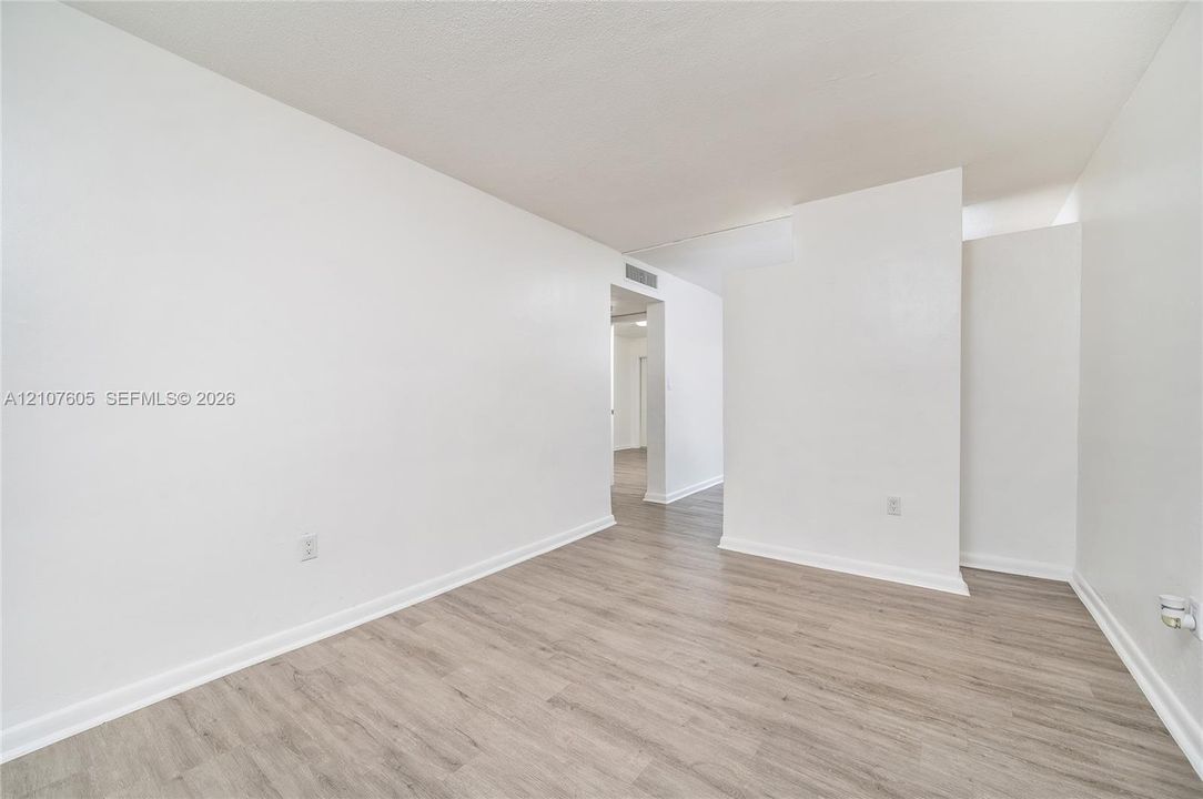 Neutral interior featuring white walls and wood-finish flooring