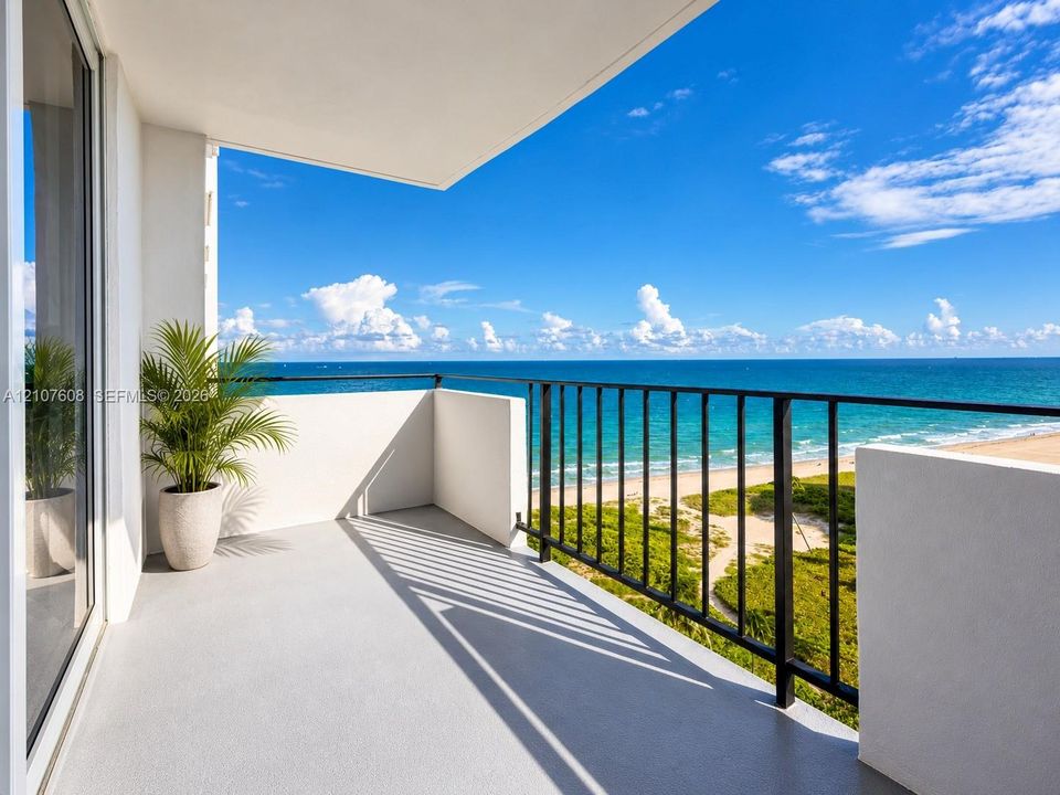 Private balcony featuring a solid surface floor, black metal railing, and direct water frontage