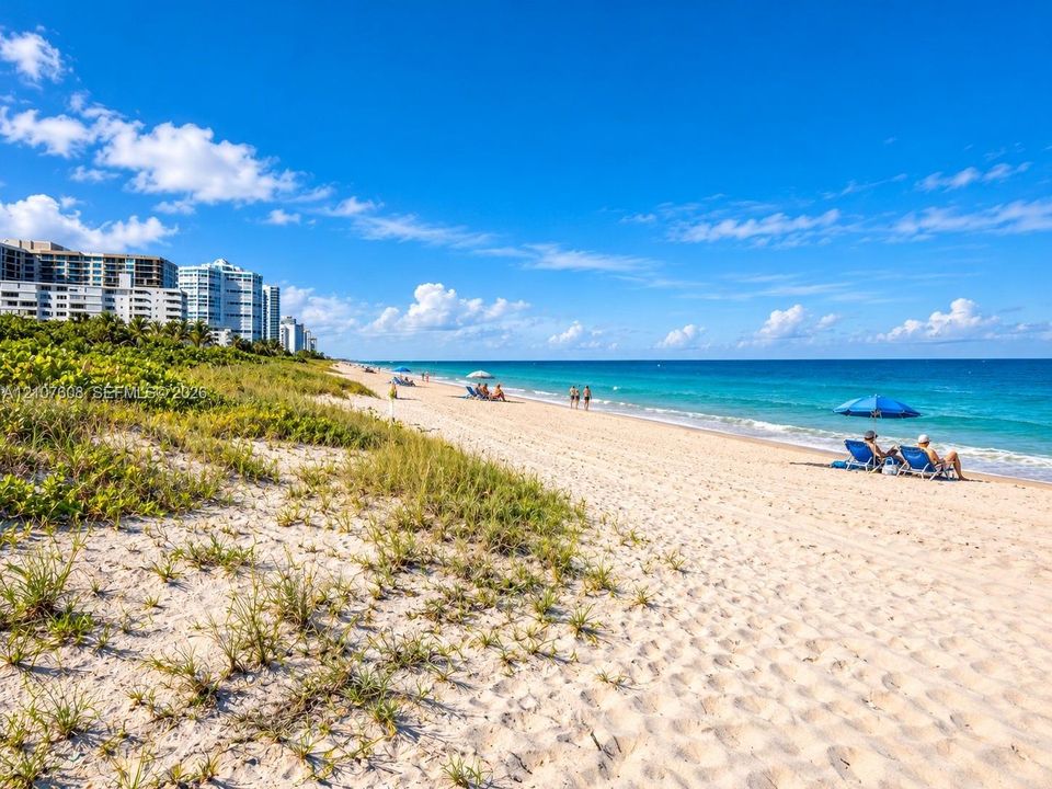 Direct oceanfront access featuring expansive sandy beach, coastal dunes with native vegetation, and panoramic sea scenery