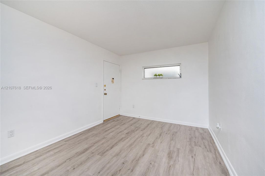 Neutral-toned wood-finish flooring and a horizontal clerestory window