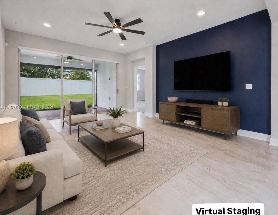 Living area featuring ceramic tile flooring, a deep blue accent wall, recessed lighting, a modern ceiling fan, and sliding glass doors
