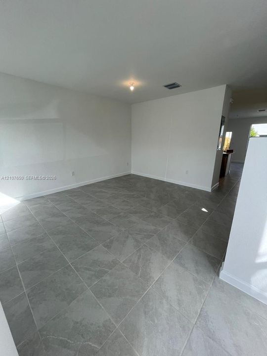 Interior space featuring neutral wall tones and large-format porcelain tile flooring