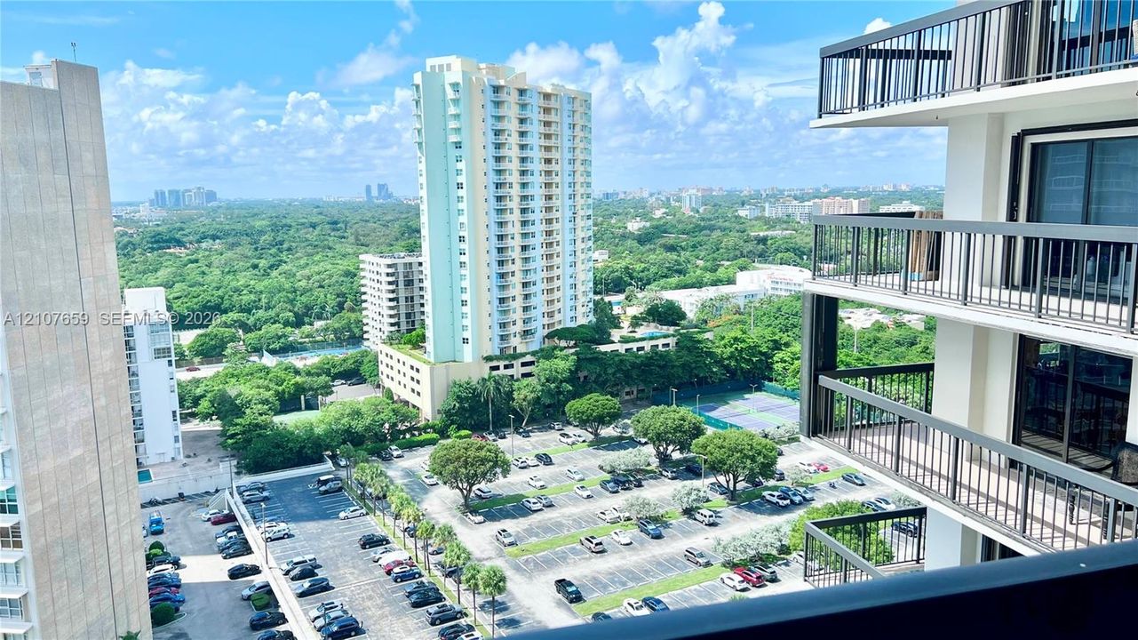 Stacked balconies with black metal railings and sliding glass door access