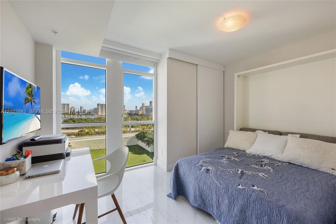 Floor-to-ceiling windows, white tile flooring, built-in wall cabinetry, and recessed ceiling lighting