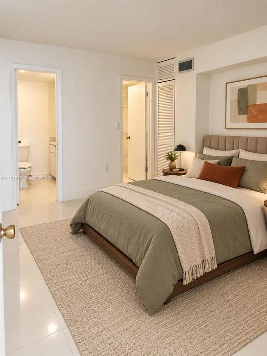 Neutral-toned interior featuring polished tile flooring, built-in louvered closet doors, and recessed lighting fixtures