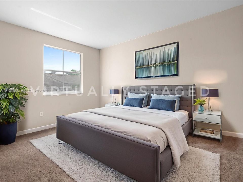 Neutral-toned walls, carpeting, and a single-pane window with natural light exposure