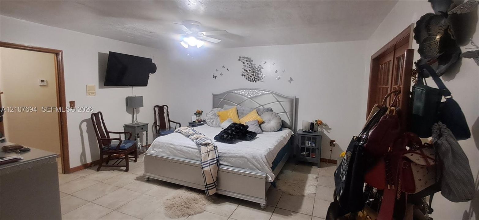 Ceramic tile flooring, ceiling fan with integrated light fixture, and interior glass-paneled doors