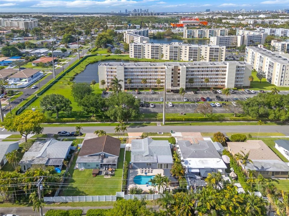 Aerial perspective featuring single-story residential architecture, private backyard swimming pools, enclosed lanais, manicured lawns, and perimeter fencing