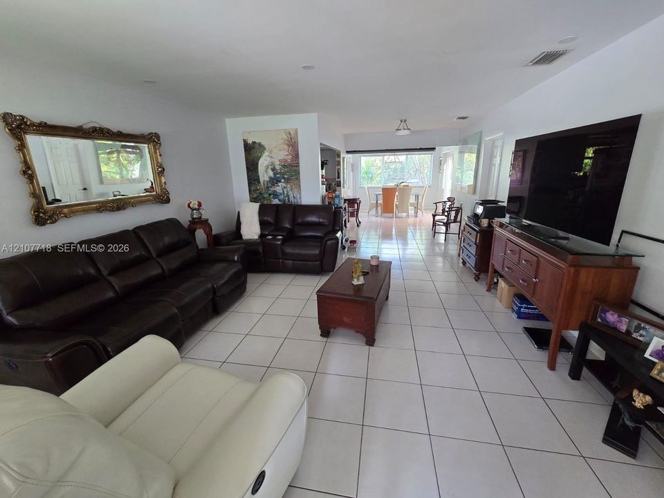 Open-concept interior featuring large-format ceramic tile flooring, recessed lighting, and expansive windows