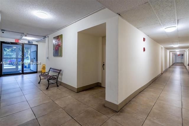 Interior hallway featuring tile flooring, neutral walls, and recessed ceiling lighting