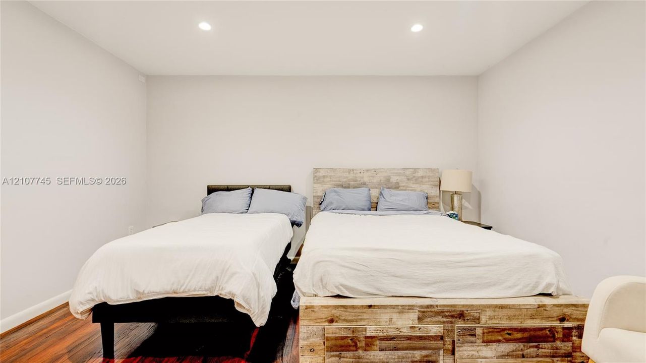 Room featuring neutral-toned walls, wood-finish flooring, and recessed ceiling lighting