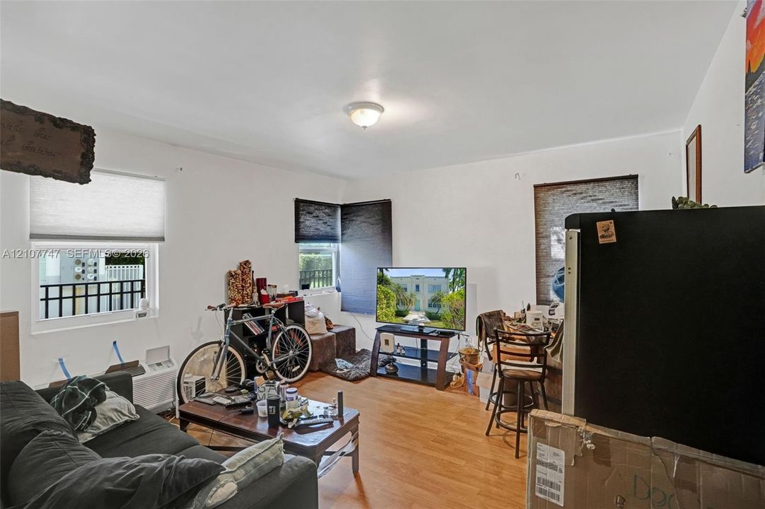 Interior space featuring wood-finish flooring, dual-pane windows, and a flush-mount ceiling light fixture