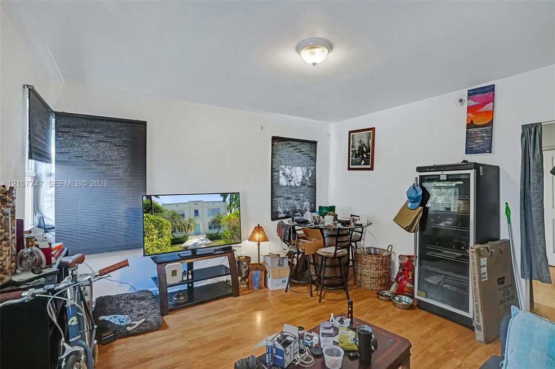 Room featuring wood-finish flooring and a central ceiling-mounted light fixture