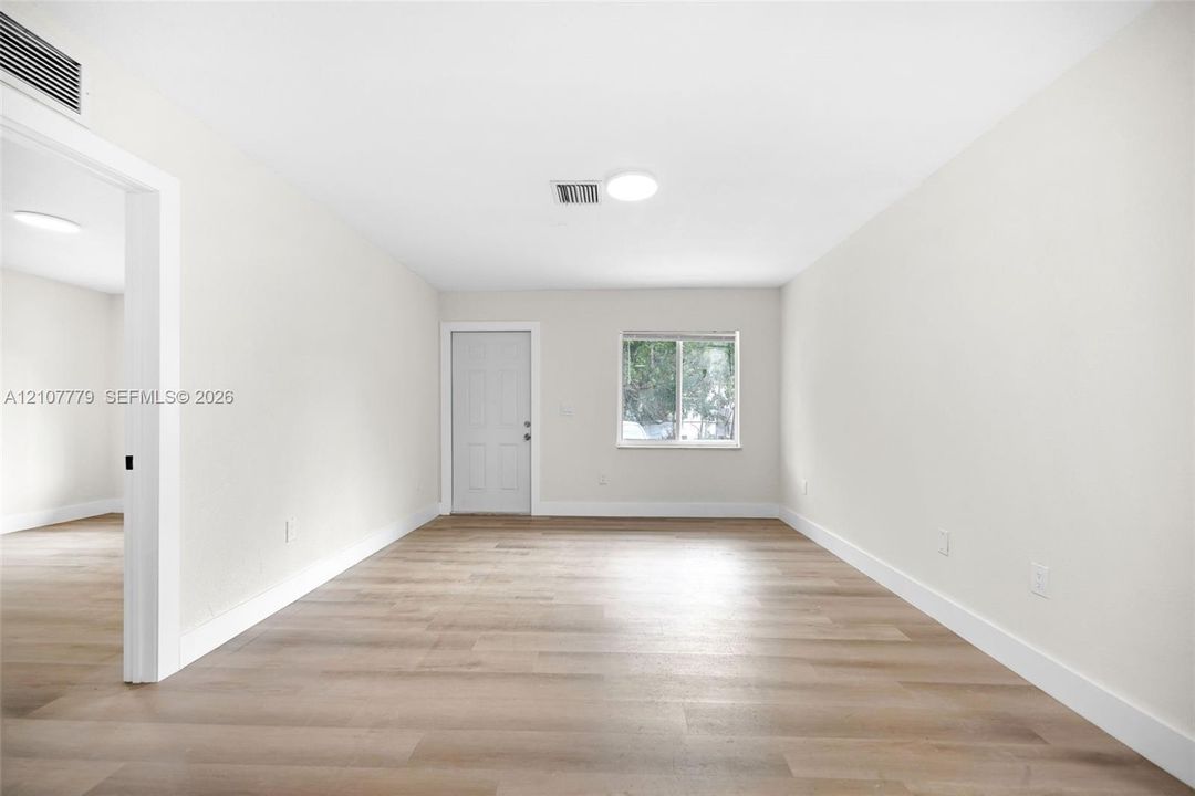 Neutral interior featuring wood-finish flooring, recessed ceiling lighting, and a single-hung window