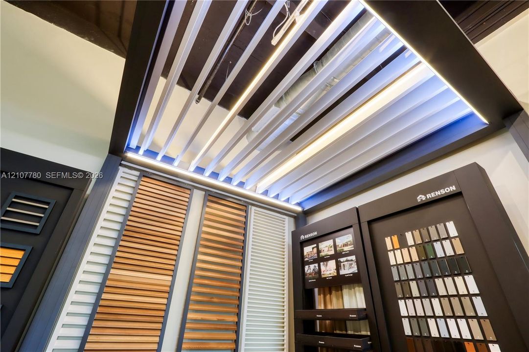 Custom motorized louvered roof system with integrated LED strip lighting, featuring operable wood-finish and metal slat panels
