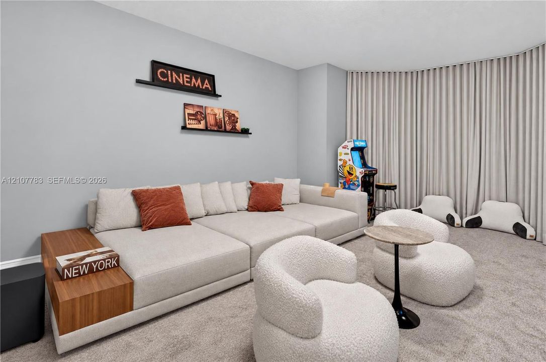 Curved wall featuring floor-to-ceiling drapery and wall-to-wall carpeting