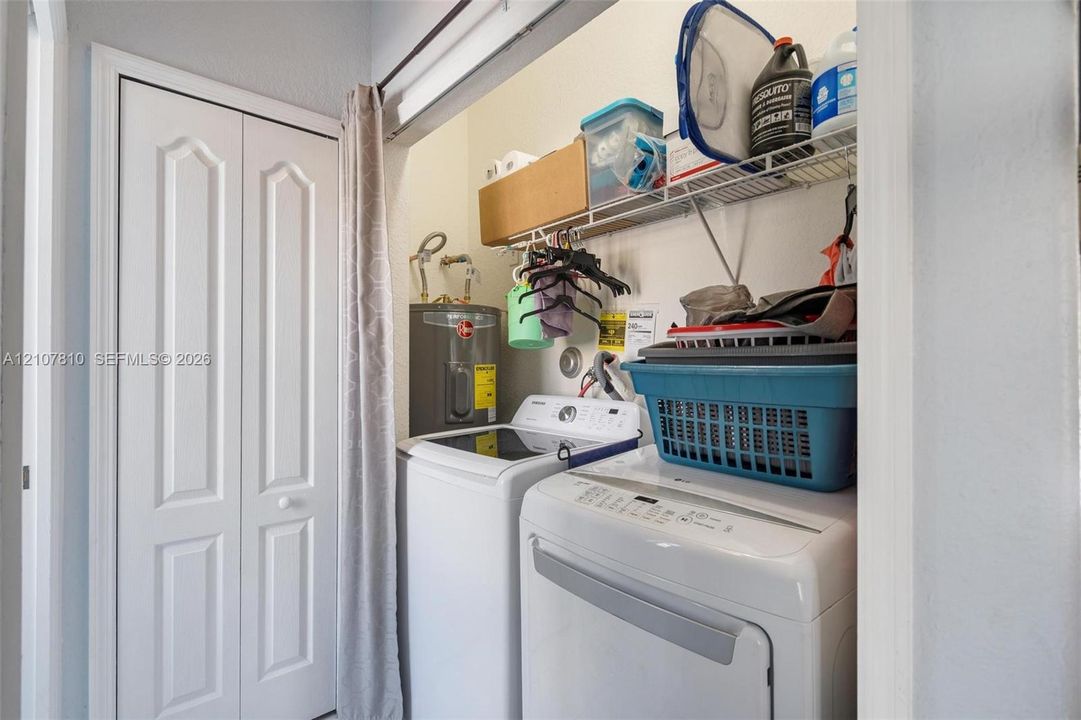 Laundry closet featuring white bi-fold doors and integrated overhead wire shelving