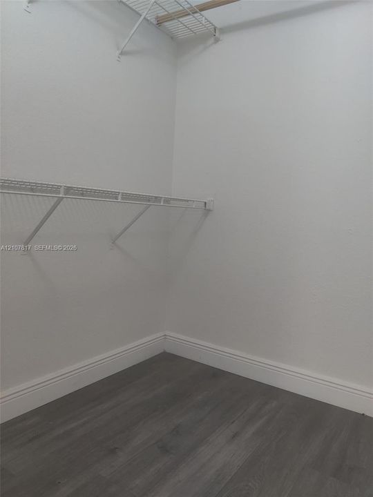 Storage area featuring wood-finish flooring and dual-level wire shelving