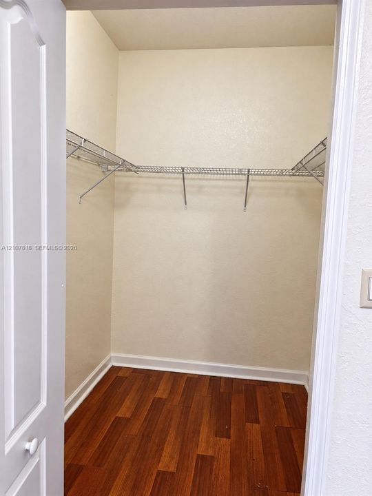 Storage closet featuring wood-finish flooring and integrated wire shelving