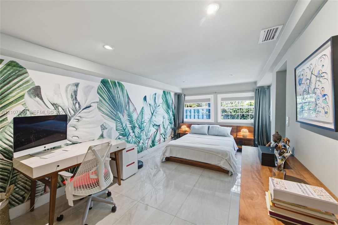 Large-format tile flooring, recessed lighting, and expansive wall-to-wall mural
