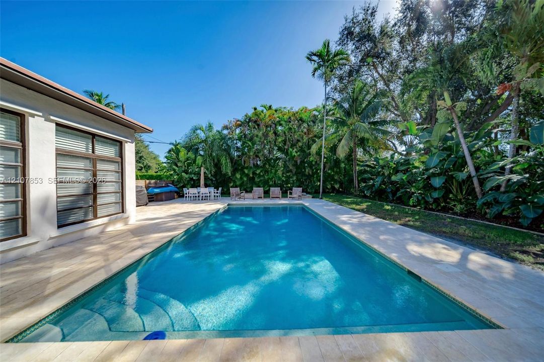 Pool perfectly placed n the private, lushly landscaped lot