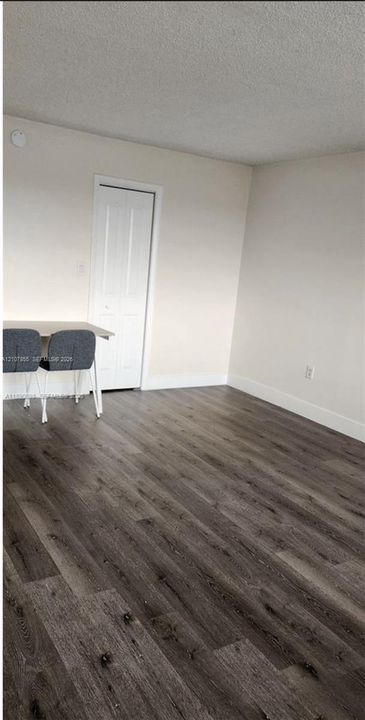 Wood-finish flooring and a white paneled door
