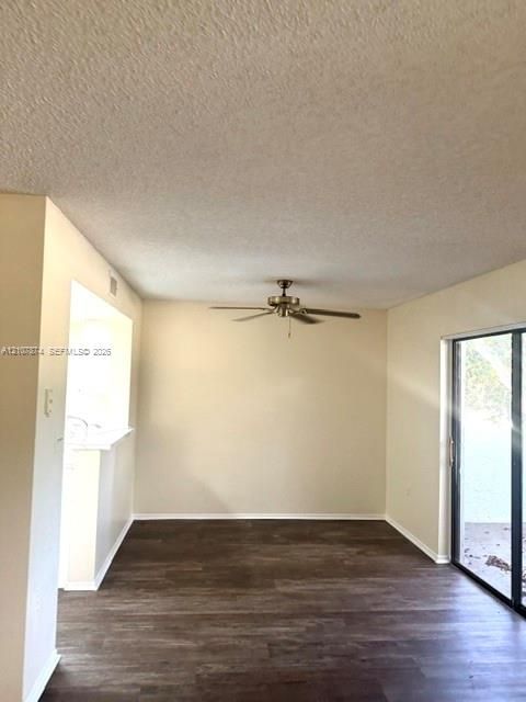 Interior space featuring wood-finish flooring, a ceiling fan with integrated lighting, and sliding glass doors