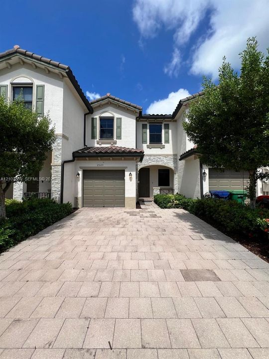 Interior space featuring large-format stone-patterned tile flooring, neutral wall finish, recessed lighting, and interior paneled doors
