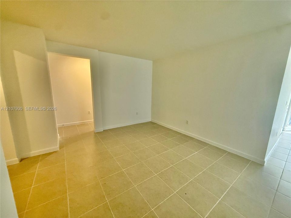 Interior space featuring neutral wall paint and light-colored square tile flooring