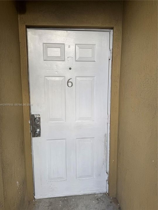 White six-panel White entry door for Apt. 6 - Third Floor