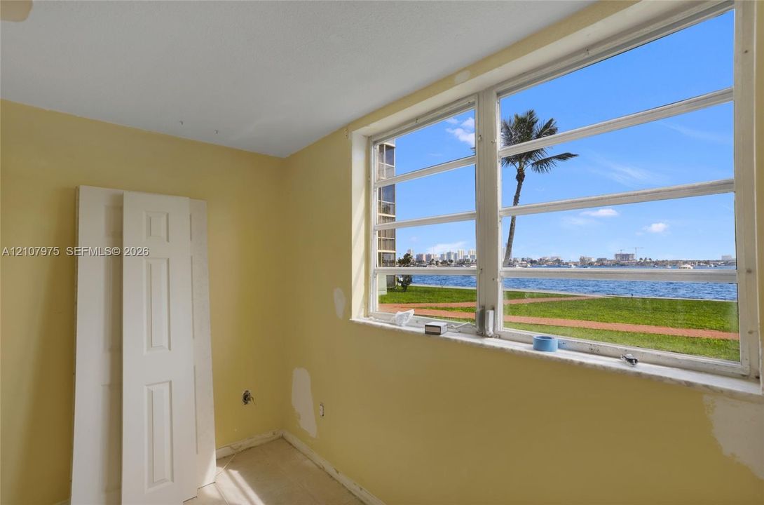Large multi-pane window with waterfront and landscape scenery