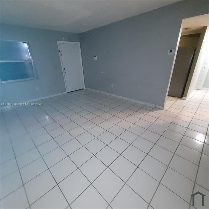 Neutral-toned walls paired with large-format square tile flooring