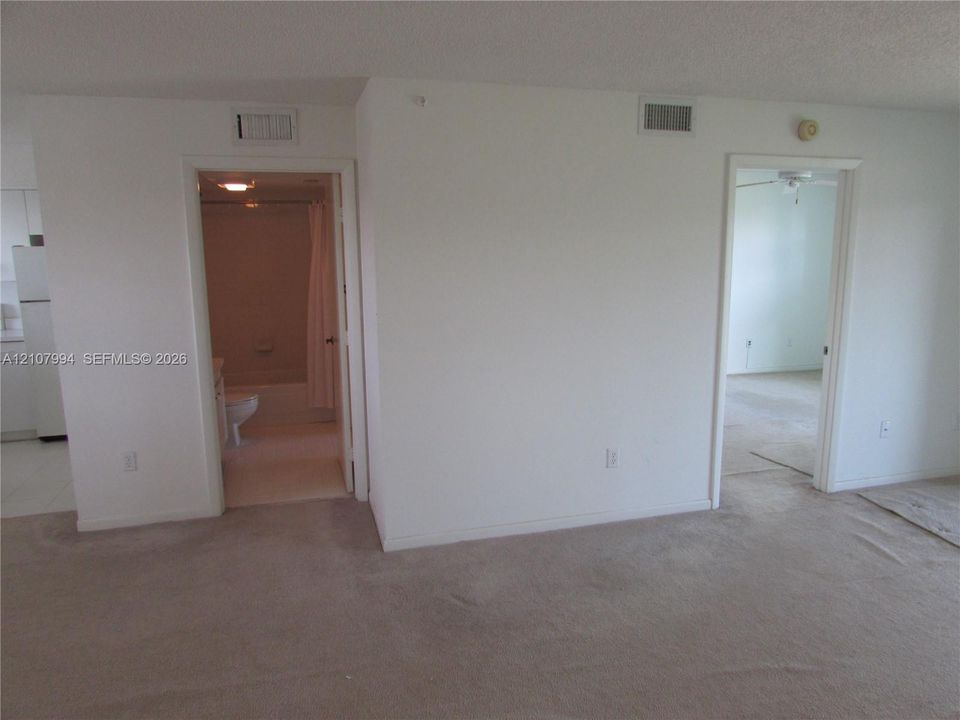 Neutral-toned wall-to-wall carpeting and standard interior doorways