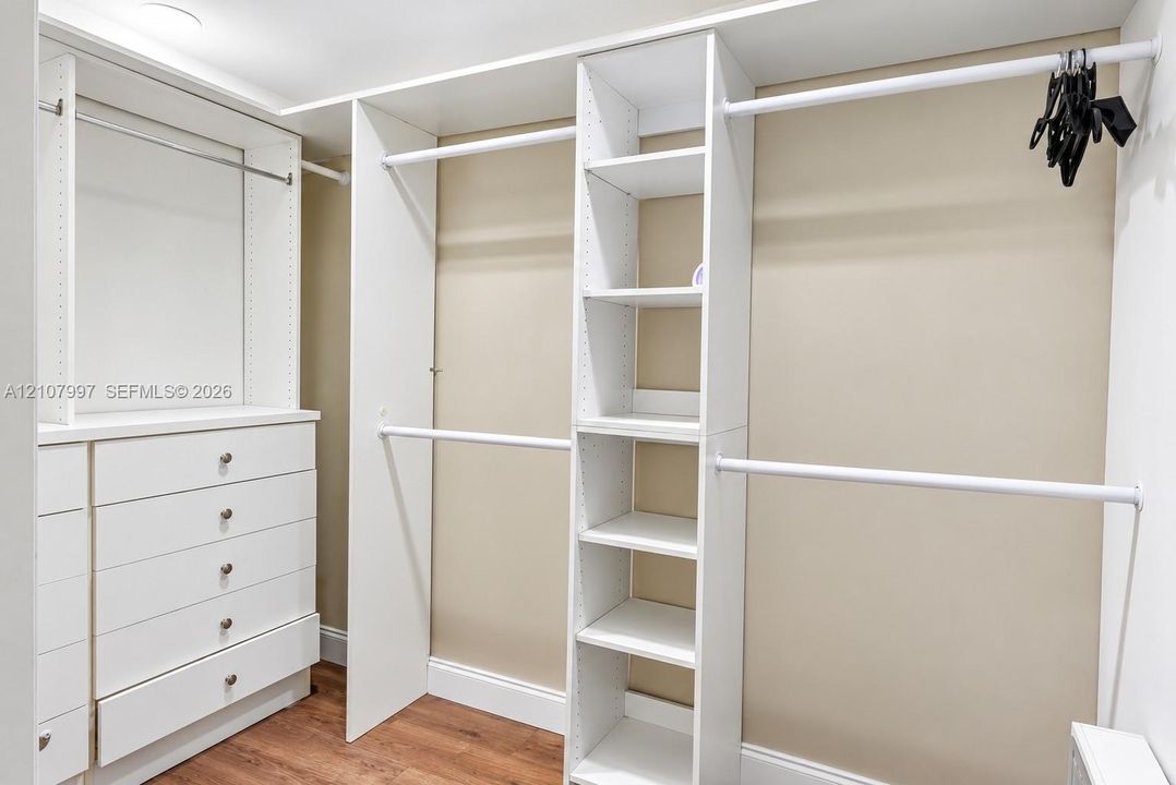 Second bedroom featuring wood-finish flooring.