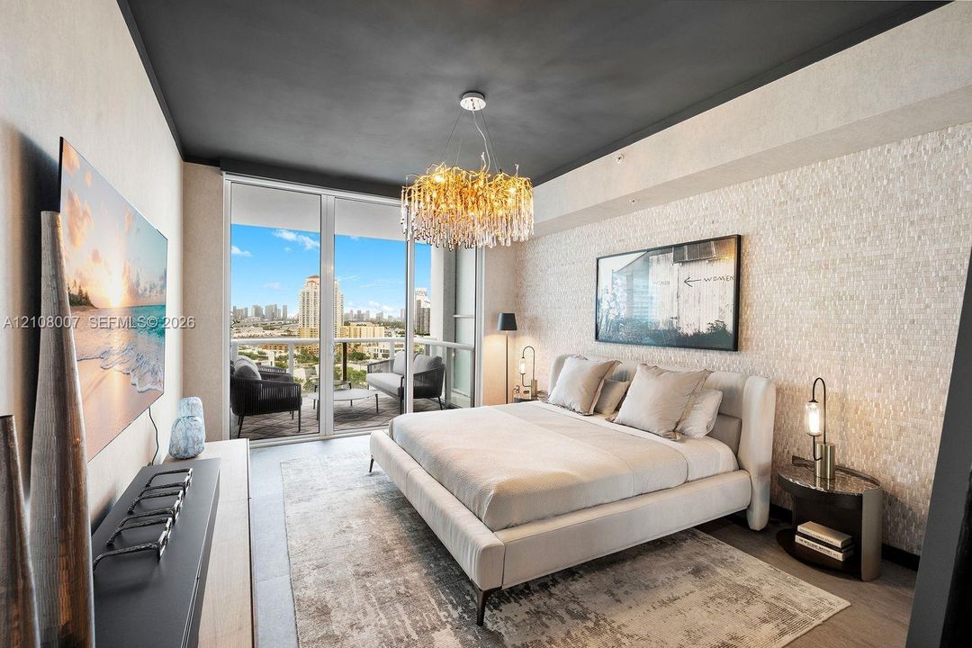Textured stone accent wall, floor-to-ceiling glass paneling, private balcony, and decorative crystal chandelier