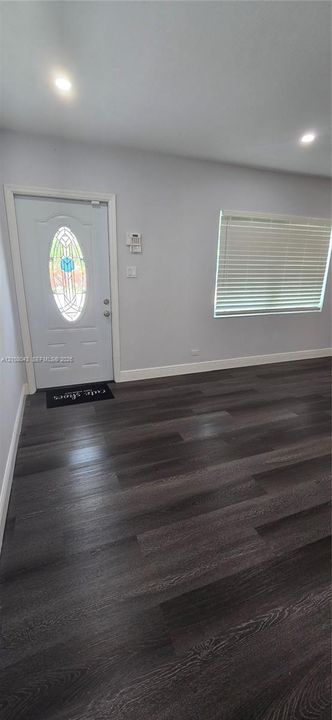 Entryway featuring wood-finish flooring, recessed lighting, and an exterior door with an oval stained-glass insert