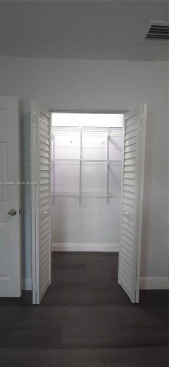 Closet featuring white louvered bifold doors and integrated white wire shelving