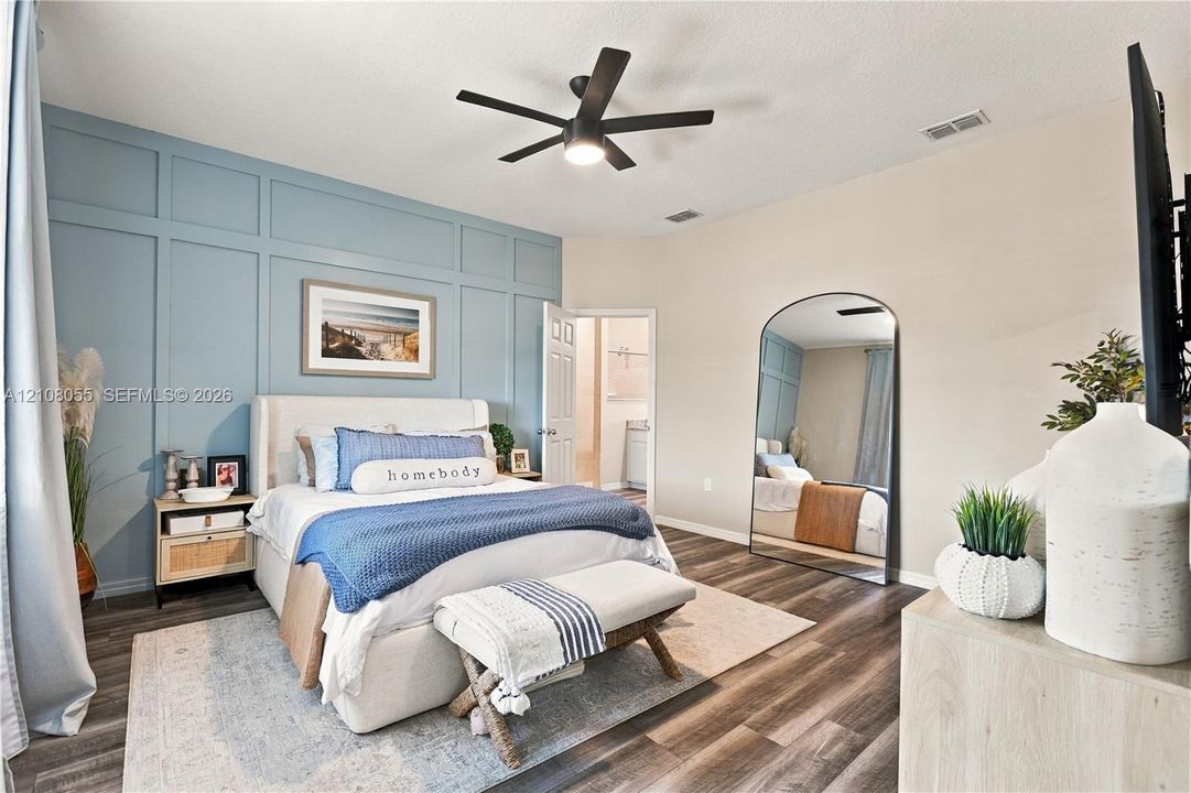 Accent wall featuring custom board-and-batten millwork, wood-finish flooring, and a modern multi-blade ceiling fan with integrated lighting