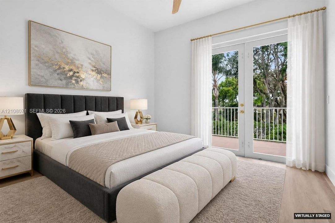 Bedroom featuring wood-finish flooring, full-length double glass doors, and a private railed balcony