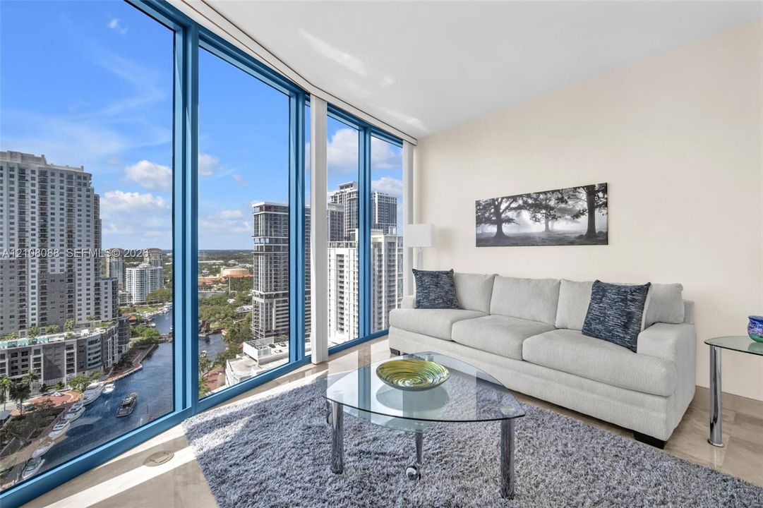 Direct New River Views. Guest bedroom set up as den or media room. Pull out queen size sleeper. Floor-to-ceiling windows featuring river and panoramic urban scenery and stone-finish flooring