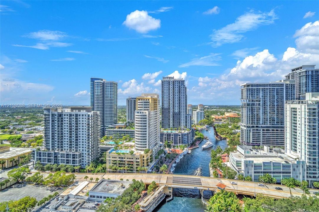 Actual view of the New River! Aerial perspective featuring an urban skyline, high-rise architecture, a waterway, and bridges