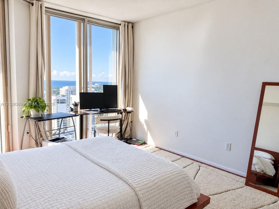 Floor-to-ceiling windows featuring expansive coastal and urban scenery