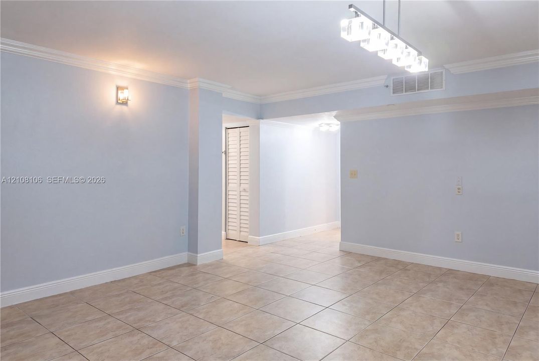 Ceramic tile flooring, crown molding, multi-light linear fixture, and louvered closet doors