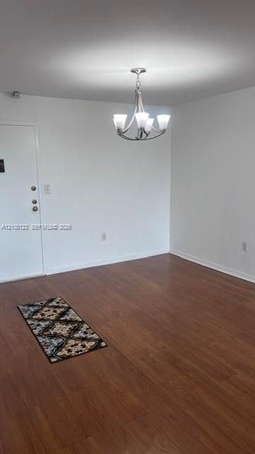 Wood-finish flooring and multi-arm chandelier with frosted glass shades