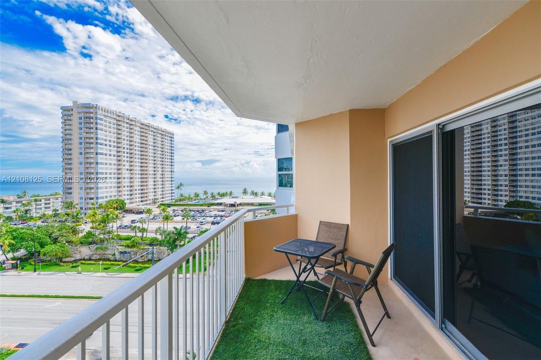 Private balcony featuring a metal railing, solid surface flooring, and sliding glass door access