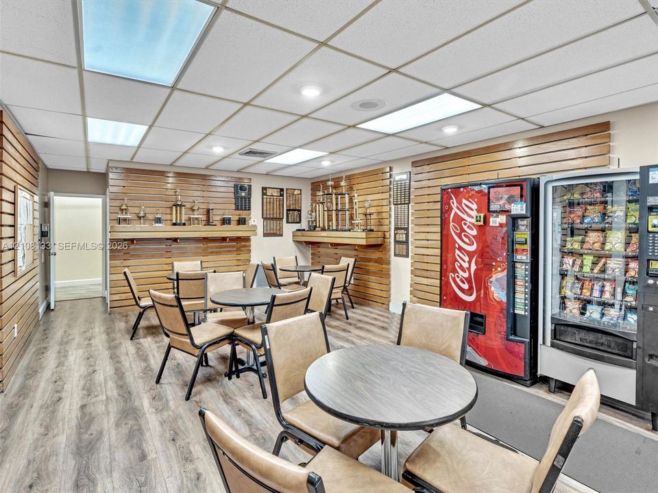 Wood-slat wall paneling, wood-finish flooring, and recessed ceiling lighting