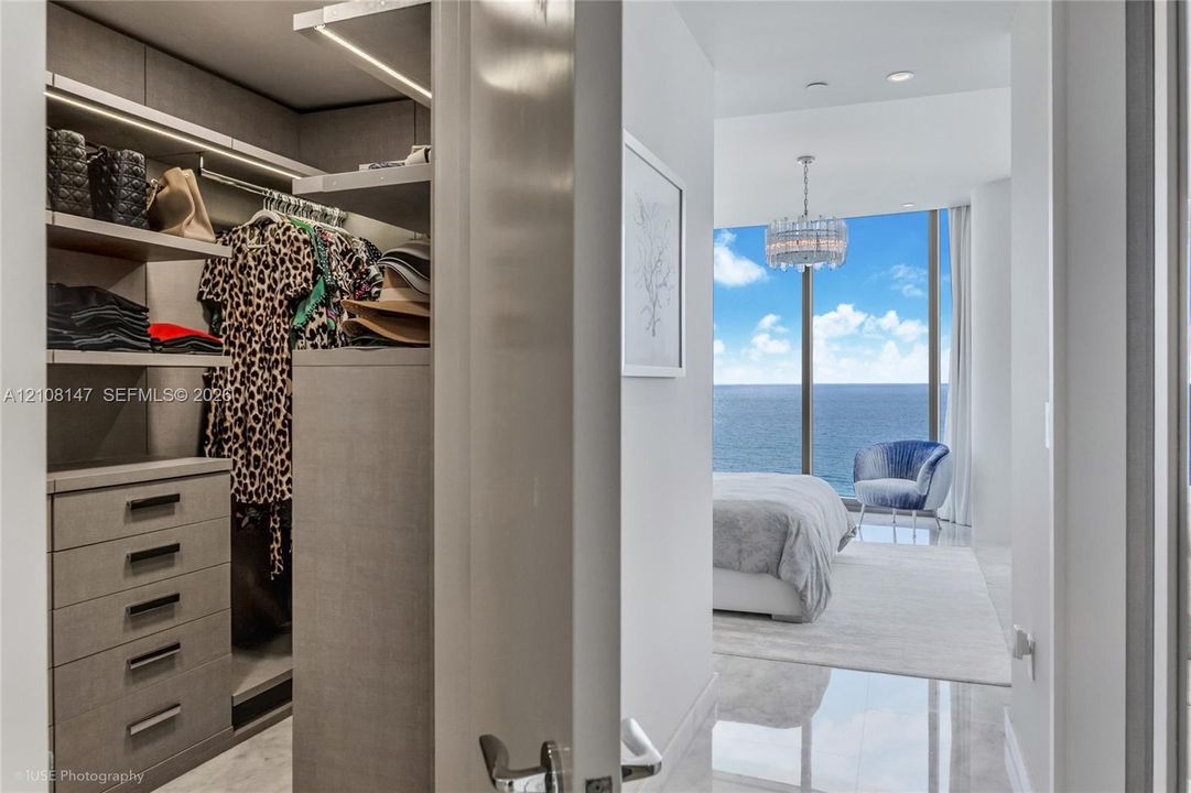 Custom walk-in closet featuring integrated shelving, LED lighting, and built-in dresser drawers